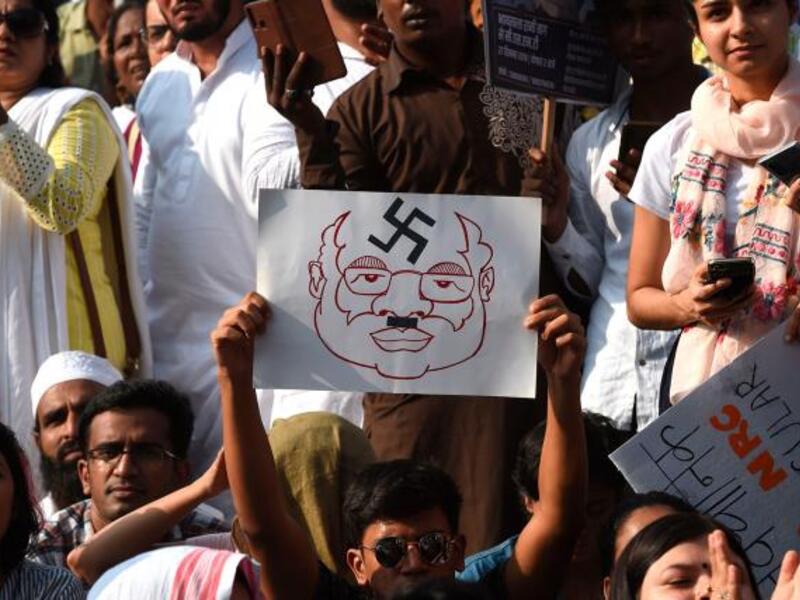 Protesters hold placards during a demonstration against India`s new citizenship law in Mumbai on 27 December, 2019. Photo: AFP