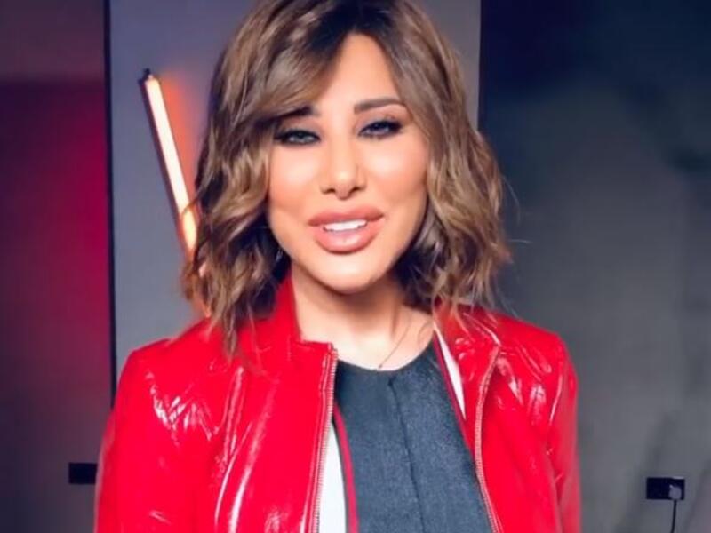 Najwa Karam threw greeting cards from an aircraft with the word "Lebnon is in our heart" greeting Lebanon and Lebanese