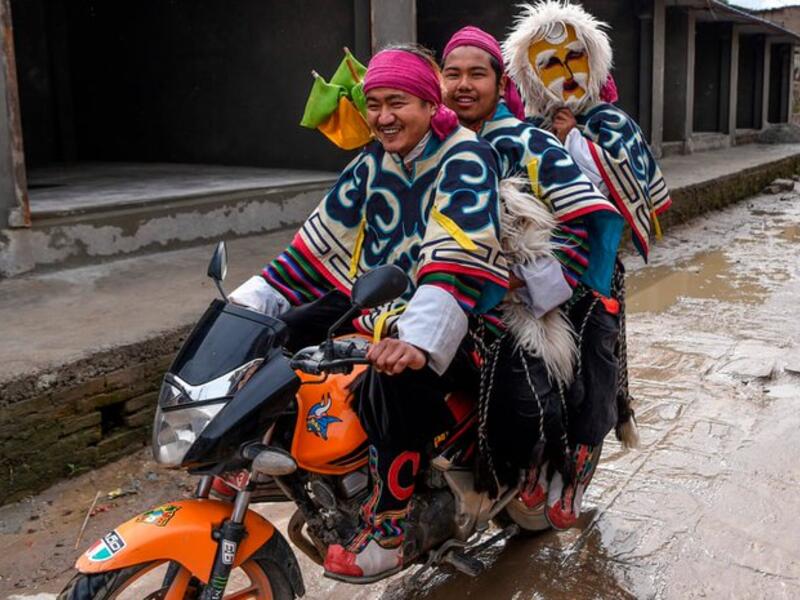 Tibetan in exile performers arrive on a motorbike before performing at the Boudhanath Stupa area during celebrations marking the third day of the Lhosar Tibetan New Year in Kathmandu (Twitter)