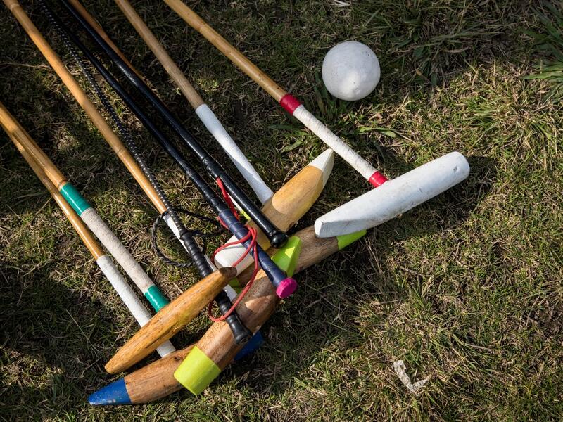 In this photograph taken on January 7, 2020, polo mallets and riding crops belonging to Linthoingambi Kangjei Lup polo club players lay on the grass before the start of their first match of the 15th Women's State Polo Tournament at the Mapal Kangjeibung (Polo Ground) in Imphal, the capital of the northeastern Indian state of Manipur. Laishram Thadoi's face is a picture of concentration as she adjusts her helmet and prepares to play in Manipur, the remote Indian state regarded as the birthplace of modern pol