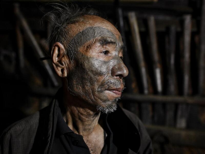 This photo taken on February 9, 2020 shows Nok Tan, 75, a tattooed Konyak tribeman, in his house in a village in Sagaing region of Myanmar, wedged in a semi-autonomous zone near the Indian border. People in the region subscribe to a complex patchwork of customs, intertwining their animist beliefs with warrior traditions that include striking tattoo designs, which can signify tribal identity, life accomplishments or the completion of a rite of passage. Ye Aung THU / AFP