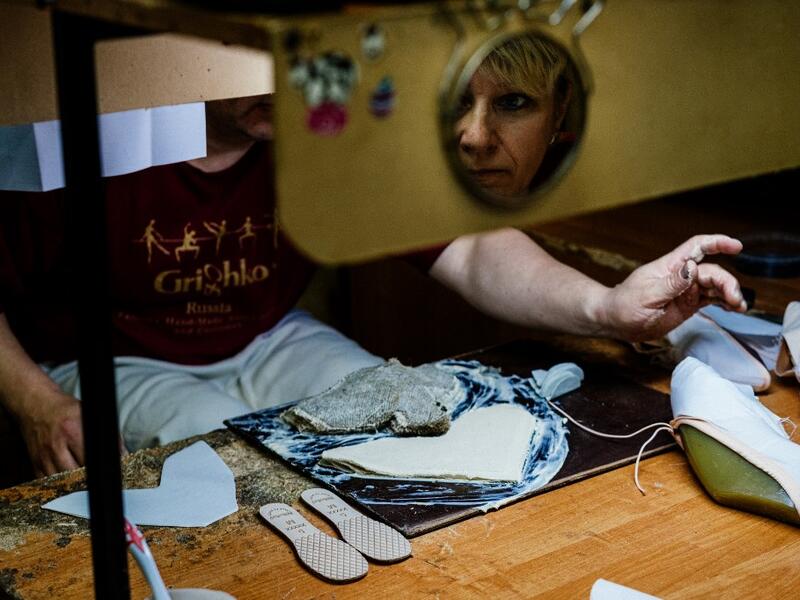 An employees of Grishko company produces pointe shoes in the company's Moscow workshop on February 25, 2020. Born in the chaos of the collapse of the Soviet Union, the Grishko family business has emerged among the top makers in the world of dance shoes, notably classic ballet pointe shoes, worn on the world's great stages. Dimitar DILKOFF / AFP