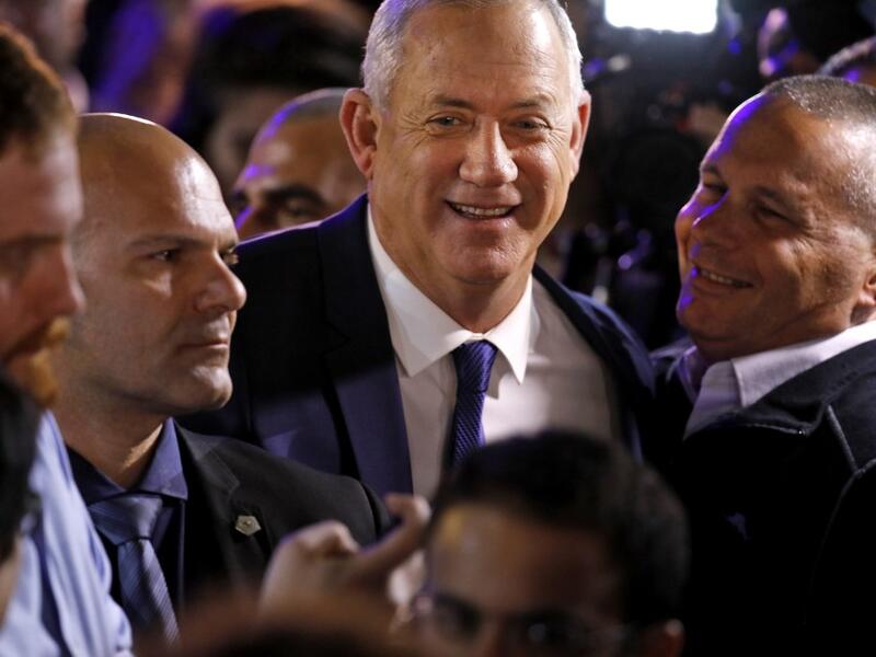 Blue and White (Kahol Lavan) electoral alliance leader Benny Gantz (C) greets supporters at their campaign headquarters in the coastal city of Tel Aviv early on March 3, 2020, after polls officially closed. Menahem KAHANA / AFP