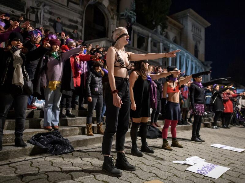 Women take part in a flashmob celebrating the International Women’s Day late on March 7, 2020 in Lausanne, western Switzerland. Fabrice COFFRINI / AFP