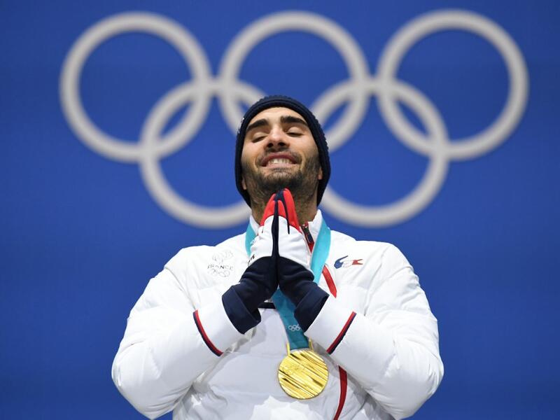 In this file photo taken on February 19, 2018 France's gold medallist Martin Fourcade reacts on the podium during the medal ceremony for the biathlon men's 15km Mass Start at the Pyeongchang Medals Plaza during the Pyeongchang 2018 Winter Olympic Games in Pyeongchang. Five-time Olympic biathlon champion Martin Fourcade announced in a statement on March 13, 2020 that he would end his career at the end of the season, after the last race which will take place on March 14 in Kontiolahti, Finland. Kirill KUDRYAV