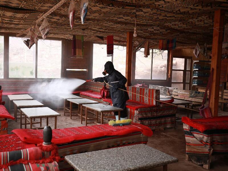 A labourer sprays disinfectant in Jordan's archaeological city of Petra south of the capital Amman on March 17, 2020, to prevent the spread of COVID-19. Khalil MAZRAAWI / afp
