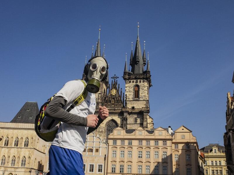 A man with a gas mask runs across the Old Town Square on March 18, 2020, in Prague, where activities came to a halt due to the spread of the novel coronavirus. The Czech Republic, a European Union country of 10.7 million people, has registered 464 confirmed cases of the virus, including three cured patients, and no deaths. Michal Cizek / AFP