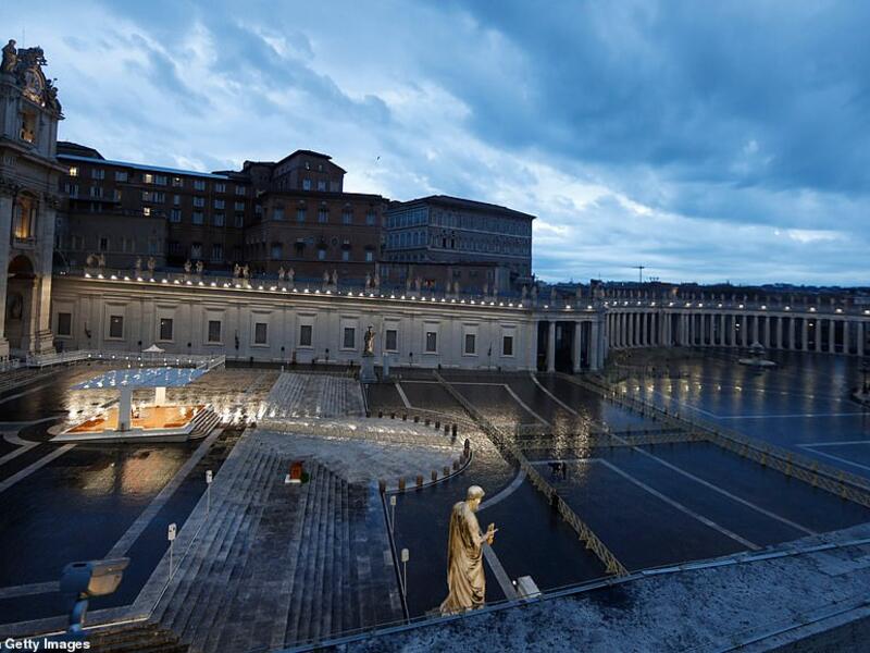 An aerial view of the Pope outside the Vatican, Rome giving the unusual 'Urbi et Orbi' blessing. He can seen here on an illuminated sheltered podium outside the entrance to the Vatican but St Peter's Square remained deserted due to lockdown. (AFP/File)