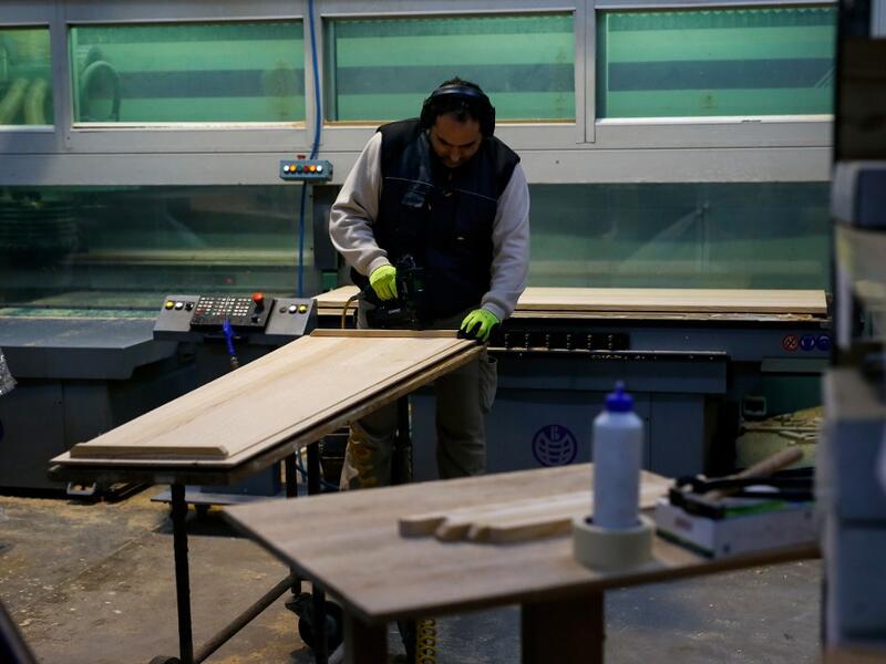 An employee works at the Eurocoffin coffins factory in Barcelona on April 3, 2020. More than 900 people died in Spain over the past 24 hours for the second day running, government figures showed, although the rate of new infections and deaths continued to slow. Spain has the world's second-highest death toll after Italy with the virus so far claiming 10,935 lives from 117,710 confirmed cases.  PAU BARRENA / AFP