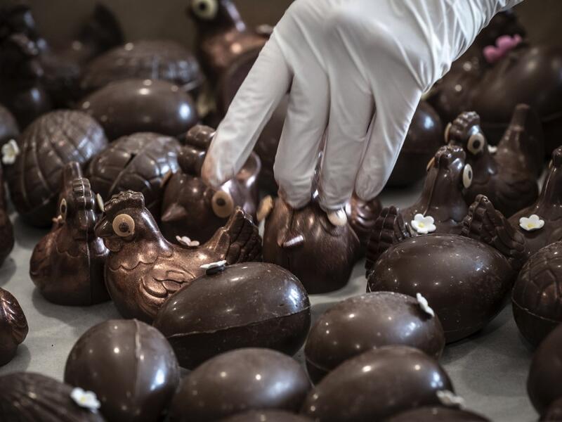 An employee of pastry and chocolate maker Didier Girard prepares Easter chocolate before delivering them at clients' homes in Vourles, near Lyon at on April 7, 2020, on the twenty-second day of a strict lockdown in France to stop the spread of COVID-19, caused by the novel coronavirus. JEAN-PHILIPPE KSIAZEK / AFP