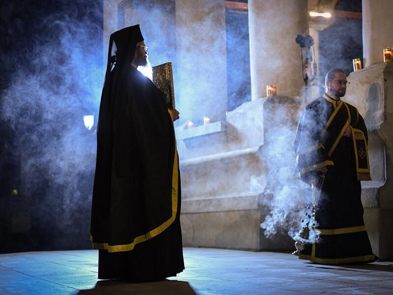 Romanian Christian Orthodox priests hold a religious service on the Good Friday, two days before Orthodox Easter celebration at the Patriarchal Cathedral in Bucharest April 17, 2020. Due to the emergency state called by the romanian authorities to slow down the coronavirus infection all the religious services will be held without believers inside or around the churches. Daniel MIHAILESCU / AFP