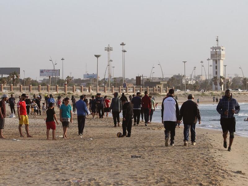 Libyans exercise at the beach before "iftar", or breaking the fast at sunset, during the Muslim holy month of Ramadan in the capital Tripoli, despite a lockdown due to the COVID-19 pandemic, on May 8, 2020. Mahmud TURKIA / AFP