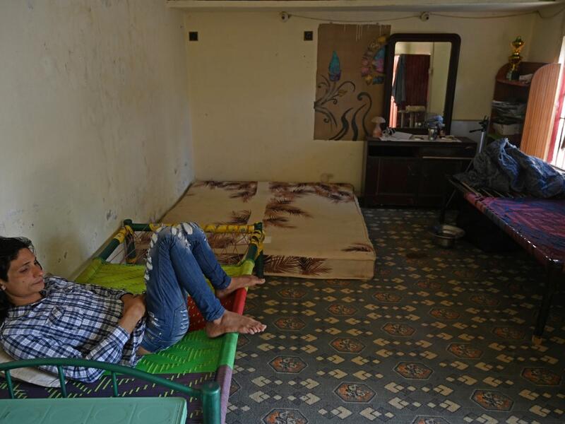 In this picture taken on May 8, 2020, member of the transgender community Adnan Ali (L) rests inside a shelter house in Bari Imam neighbourhood of Islamabad. Transgender people in the country are known as "khawajasiras" or "hijras" -- an umbrella term denoting a third sex that includes transgender women and cross-dressers. Pakistan became one of the first countries in the world to legally recognise a third sex in 2009 and began issuing transgender passports from 2017. Aamir QURESHI / AFP