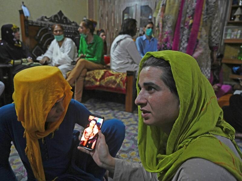 In this picture taken on May 9, 2020, members of the transgenders community gather to break their fast during the Islamic holy month of Ramadan at the Guru transgender house in Rawalpindi. Transgender people in the country are known as "khawajasiras" or "hijras" -- an umbrella term denoting a third sex that includes transgender women and cross-dressers. Pakistan became one of the first countries in the world to legally recognise a third sex in 2009 and began issuing transgender passports from 2017. Aamir QU