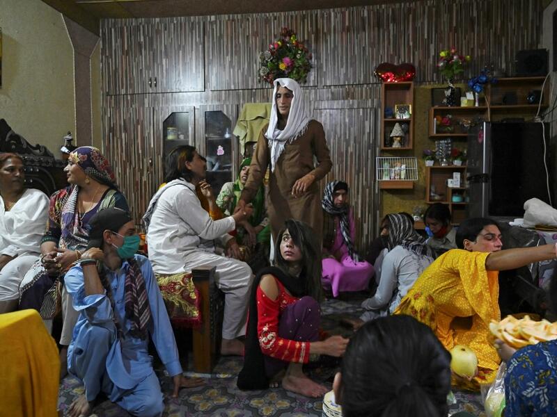 In this picture taken on May 9, 2020, members of the transgenders community gather to break their fast during the Islamic holy month of Ramadan at the Guru transgender house in Rawalpindi. Transgender people in the country are known as "khawajasiras" or "hijras" -- an umbrella term denoting a third sex that includes transgender women and cross-dressers. Pakistan became one of the first countries in the world to legally recognise a third sex in 2009 and began issuing transgender passports from 2017. Aamir QU