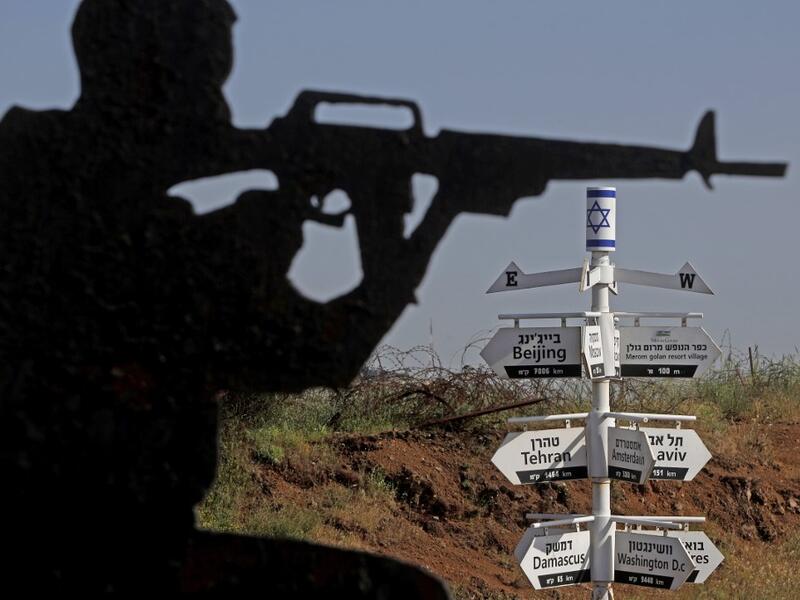 This picture taken on May 12, 2020 from a tourist lookout point at an Israeli army outpost on Mount Bental in the Israeli-annexed Golan Heights shows a directional sign for cities and places across the world and listing their respective distances. JALAA MAREY / AFP