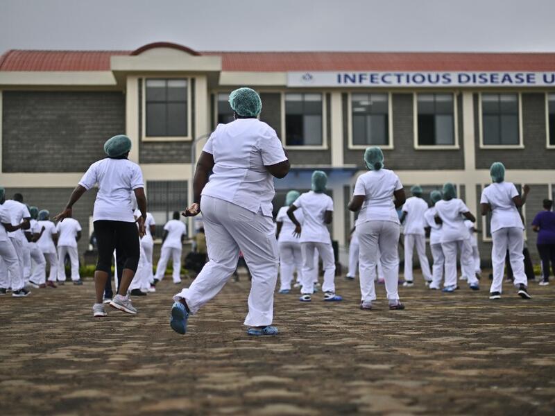 Nurses assigned to the Infectious Diseases Unit (IDU) at the Kenyatta University Hospital dance during a Zumba class held at the hospital compound in Nairobi, on May 17, 2020. Coinciding with the morning shift rotation the class, aimed to offer some respite to nurses charged with the management of patients infected with COVID-19 coronavirus, was organised by the Nursing Council of Kenya (NCK) and the Kenyatta Univesity Teaching, Refferal and Research Hospital in the Kenyan capital. TONY KARUMBA / AFP
