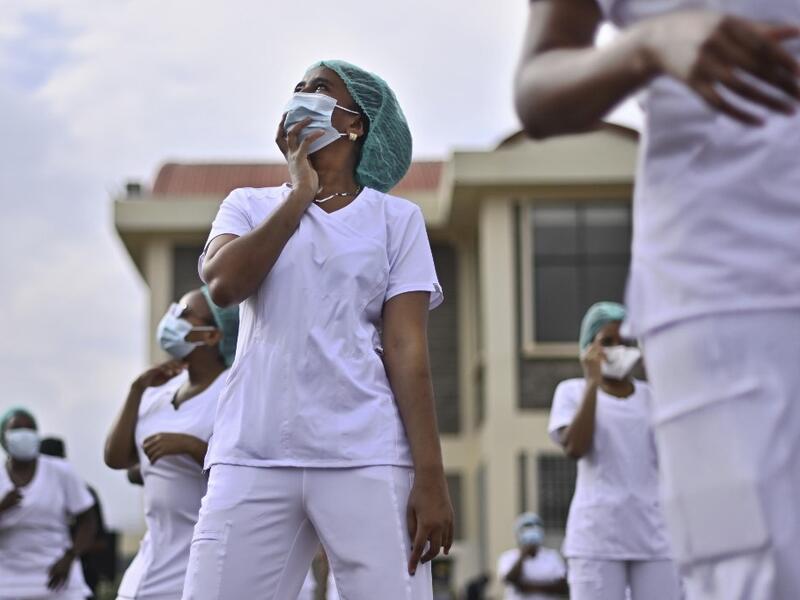 Nurses assigned to the Infectious Diseases Unit (IDU) at the Kenyatta University Hospital dance during a Zumba class held at the hospital compound in Nairobi, on May 17, 2020. Coinciding with the morning shift rotation the class, aimed to offer some respite to nurses charged with the management of patients infected with COVID-19 coronavirus, was organised by the Nursing Council of Kenya (NCK) and the Kenyatta Univesity Teaching, Refferal and Research Hospital in the Kenyan capital. TONY KARUMBA / AFP