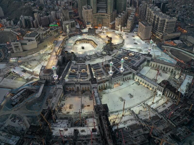 This picture taken on May 24, 2020 during the early hours of Eid al-Fitr, the Muslim holiday which starts at the conclusion of the holy fasting month of Ramadan, shows an aerial view of the Grand Mosque and Kaaba in the centre of Saudi Arabia's holy city of Mecca. Saudi Arabia began a five-day, round-the-clock curfew from May 23 after COVID-19 coronavirus infections more than quadrupled since the start of Ramadan to around 68,000 -- the highest in the Gulf. STR / AFP