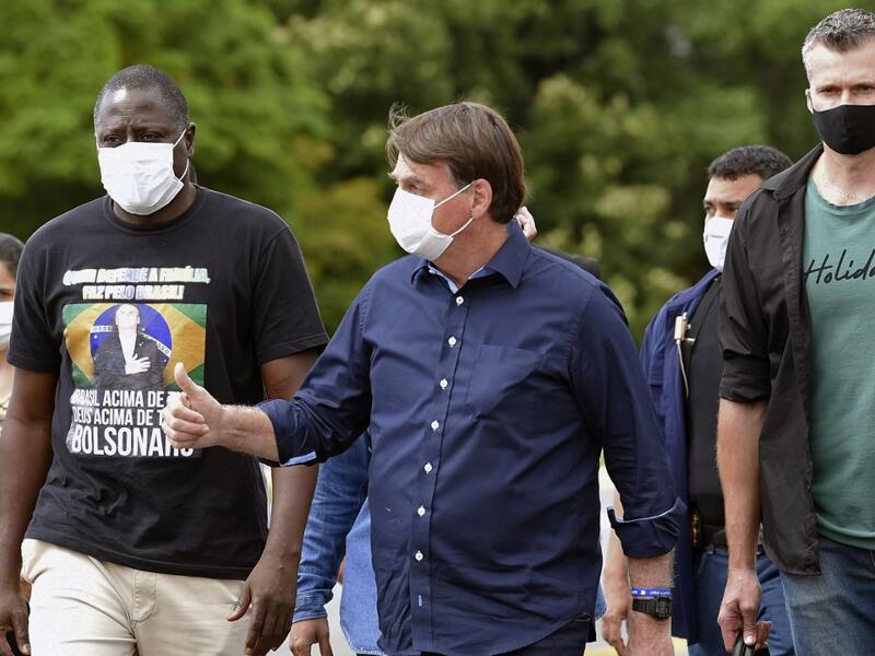Brazil's President Jair Bolsonaro gives his thumb up upon arrival at Planalto Palace in Brasilia, on May 24, 2020, amid the COVID-19 coronavirus pandemic. Despite positive signs elsewhere, the disease continued its surge in large parts of South America, with the death toll in Brazil passing 22,000 and infections topping 347,000, the world's second-highest caseload. EVARISTO SA / AFP