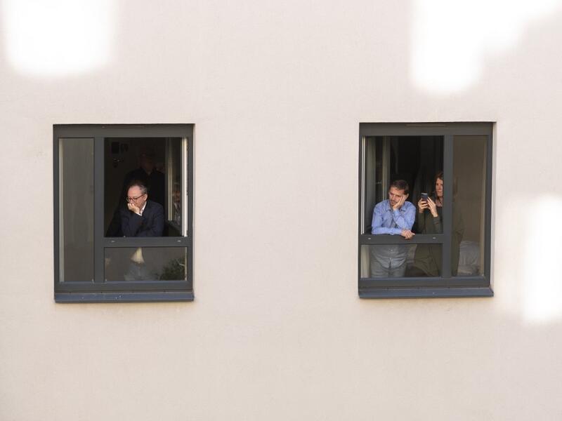 Guests of Zeitgeist Hotel listen from their rooms to singers Monika Medek and Dagmar Dekanovsky and the Camerata Carnutum orchestra, during a window concert (Fensterkonzert) in Vienna on May 30, 2020, as hotels have reopened in Austria amid the novel coronavirus pandemic. JOE KLAMAR / AFP
