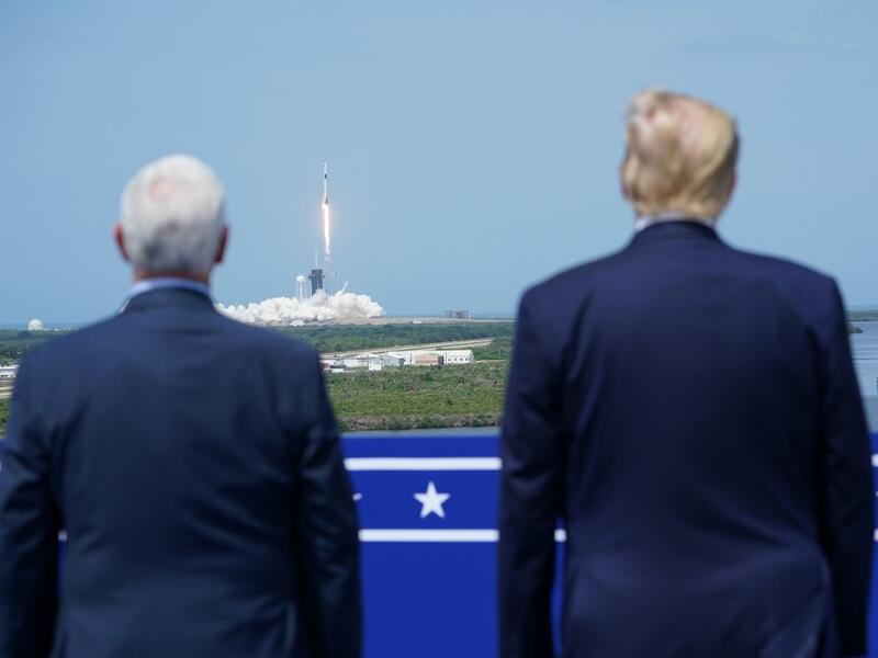 US President Donald Trump watches the SpaceX Falcon 9 rocket carrying the SpaceX Crew Dragon capsule, with astronauts Bob Behnken and Doug Hurley, lifts off from Kennedy Space Center in Florida on May 30, 2020. Trump travels to Kennedy Space Center in Florida to watch the launch of the manned SpaceX Demo-2 mission to the International Space Station. MANDEL NGAN / AFP