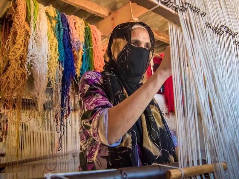 A Moroccan rug weaver creates a carpet at a workshop in the city of Sale, north of the capital Rabat, on June 3, 2020, during the novel coronavirus pandemic. Artisans in Morocco have been starved of income for almost three months because of the COVID-19 pandemic. The crafts industry represents some seven percent of GDP, with an export turnover last year of nearly 1 billion dirhams ($100 million). FADEL SENNA / AFP