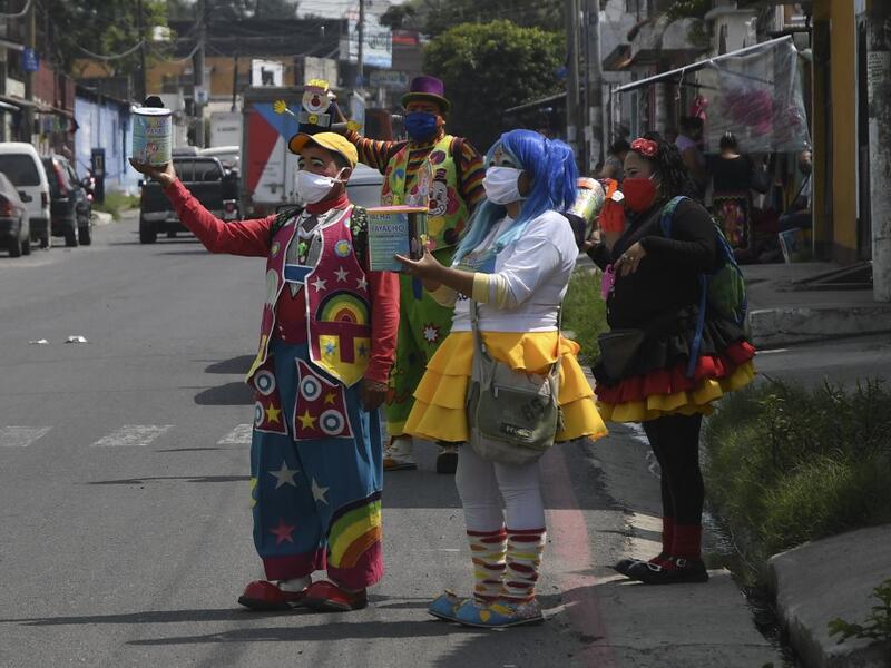 A group of clowns beg for money to survive the crisis caused by the new coronavirus in Villa Nueva, 20 km south Guatemala City, on June 10, 2020, as clowns have been unable to work due to restrictions to prevent the spread of the COVID-19.    Johan ORDONEZ / AFP