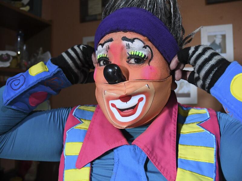 Mostacita.com clown prepares before taking to the streets to beg for money to survive the crisis caused by the new coronavirus in Villa Nueva, 20 km south Guatemala City, on June 10, 2020, as clowns have been unable to work due to restrictions to prevent the spread of the COVID-19. Johan ORDONEZ / AFP