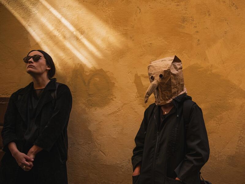 Visitors are pictured on May 30 ,2020 during a 'plague walk' tour by guide Mike Anderson , taking them around sites in Stockholm's old town related to pandemics of the plague in the 14th and 18th century, and an outbreak of cholera that hit the city in the mid-19th century. Jonathan NACKSTRAND / AFP