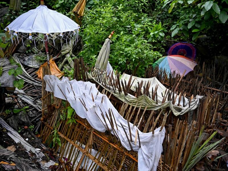 This picture taken on February 20, 2020 shows bamboo cages which cover bodies at a cemetery where Bali's Trunyanese people hold open-air burials - before restrictions were implemented due to the COVID-19 coronavirus - near the village of Trunyan in Bangli Regency, near Lake Batur on Bali island. SONNY TUMBELAKA / AFP