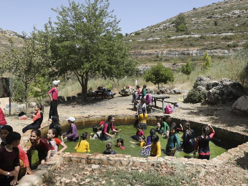 Israeli children from the nearby settlement of Shilo are pictured at a water spring on June 8, 2020 near the Palestinian village of Turmus‘ayya in the occupied West Bank. The government of Israeli Prime Minister Benjamin Netanyahu has said it could begin the process to annex Jewish settlements in the West Bank as well as the strategic Jordan Valley from July 1. The plan -- endorsed by Washington -- would see the creation of a Palestinian state, but on reduced territory, and without Palestinians' core demand