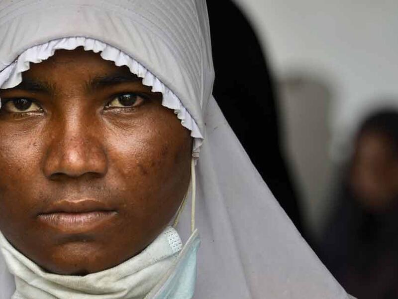 A Rohingya from Myanmar gets her identification photograph taken by Indonesian police at the immigration detention centre in Lhokseumawe, in Indonesia's North Aceh Regency. (AFP Photo)