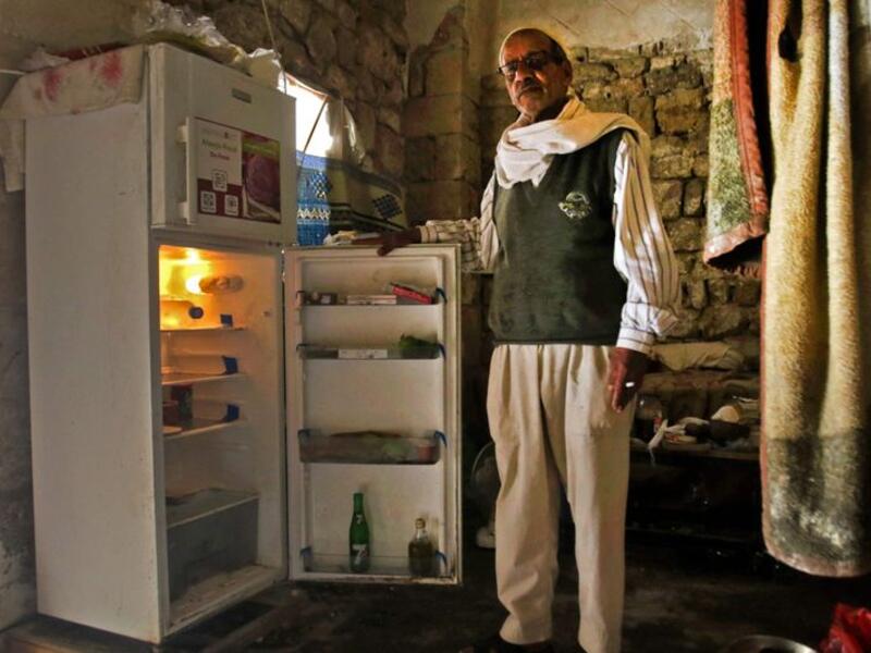 A Lebanese man displays the content of his refrigerator at his apartment in the southern city of Sidon. Image Credit: AFP