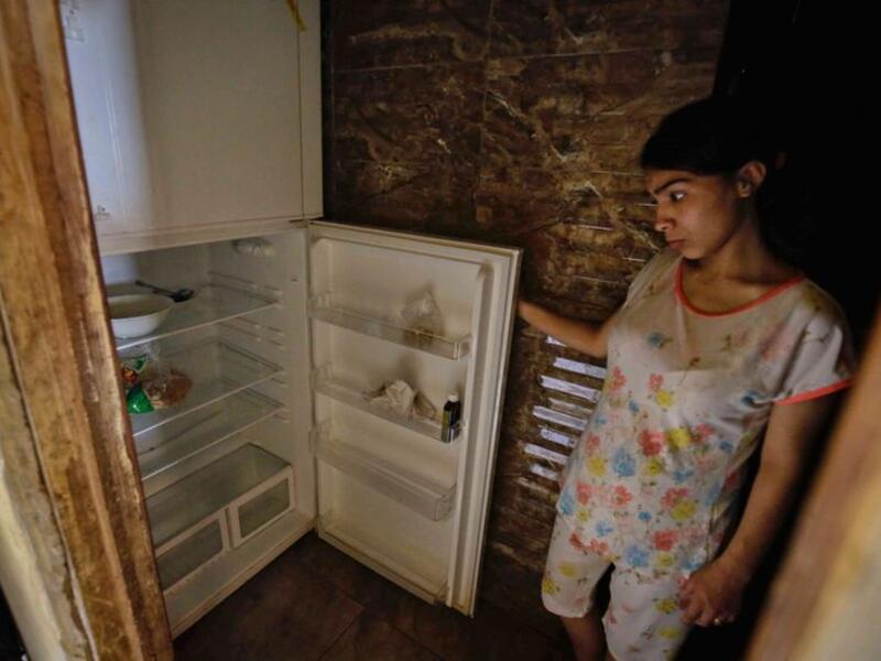 Those who accepted to be photographed posed in front of open refrigerators whose bare shelves often hinted at the leanest of diets. Image Credit: AFP