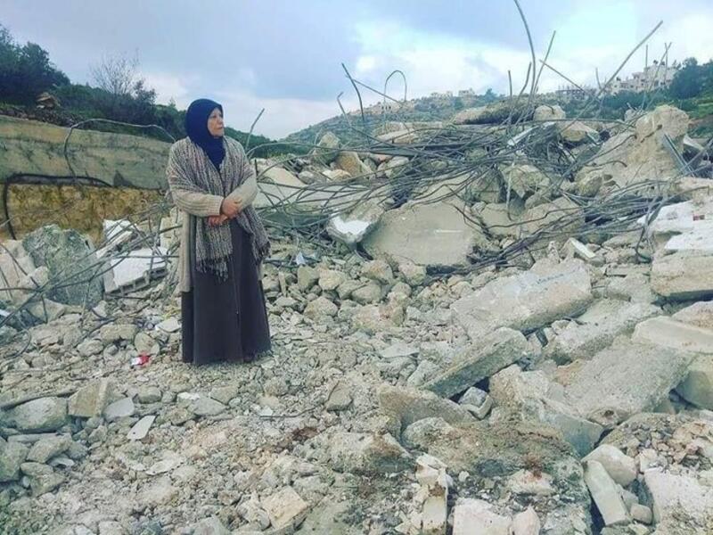 Mother of Palestinian_prisoner Asem al-Barghouti is standing on the rubble of his house which was demolished this night (Twitter)