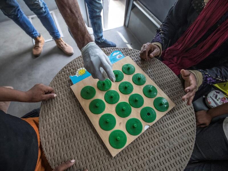 Homeless children play an educational game with a social worker inside one of the mobile units run by the Egyptian authorities and used as part of the "Atfal bala ma'wa" (Children without a home) social program, in the capital Cairo's Abbasia district on June 22, 2020. Khaled DESOUKI / AFP