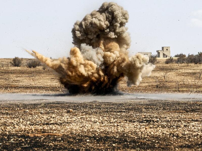 A landmine is remotely detonated in a field at a pistachio orchard in the village of Maan, north of Hama in west-central Syria on June 24, 2020. Pistachio farmers in central Syria are hoping that reduced violence will help revive cultivation of what was once one of the country's top exports. LOUAI BESHARA / AFP