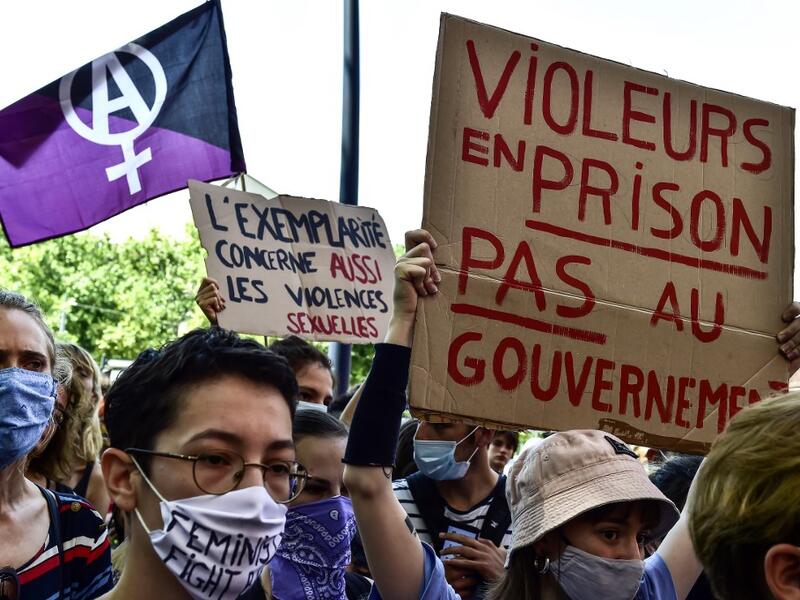 People gathered to protest against France's new Interior Minister Gerald Darmanin, aged 37, whose promotion has outraged feminists because of a years-old rape claim that remains under investigation, and against France's new Justice Minister Eric Dupond-Moretti, who aroused the ire of feminists by criticising the #MeToo movement against sexual harassment, saying such complaints "should be made not to the media, not on social networks, but to the judiciary." GEORGES GOBET / AFP