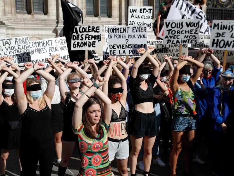 Protesters perform a dance inspired by the Chilean feminist group "Las Tesis" during a demonstration called by feminist movements in front of the city hall in Paris, on July 10, 2020, to denounce the nomination of French Interior Minister, facing rape accusations and French Justice Minister who criticised the #MeToo movement against sexual harassment. Thomas COEX / AFP