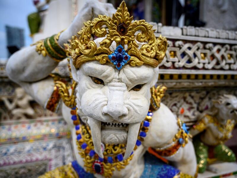 This photograph taken on July 14, 2020 shows a statue of an imaginary creature outside the Wat Pariwat Buddhist temple in Bangkok. Wat Pariwat, also known as "the David Beckham Temple", is decorated with statues of superheroes and comic characters as well as mythical and imaginary creatures. A golden-plated sculpture of the English football player holding the base of a Buddha statue in one of the buildings gives the temple its nickname. Mladen ANTONOV / AFP