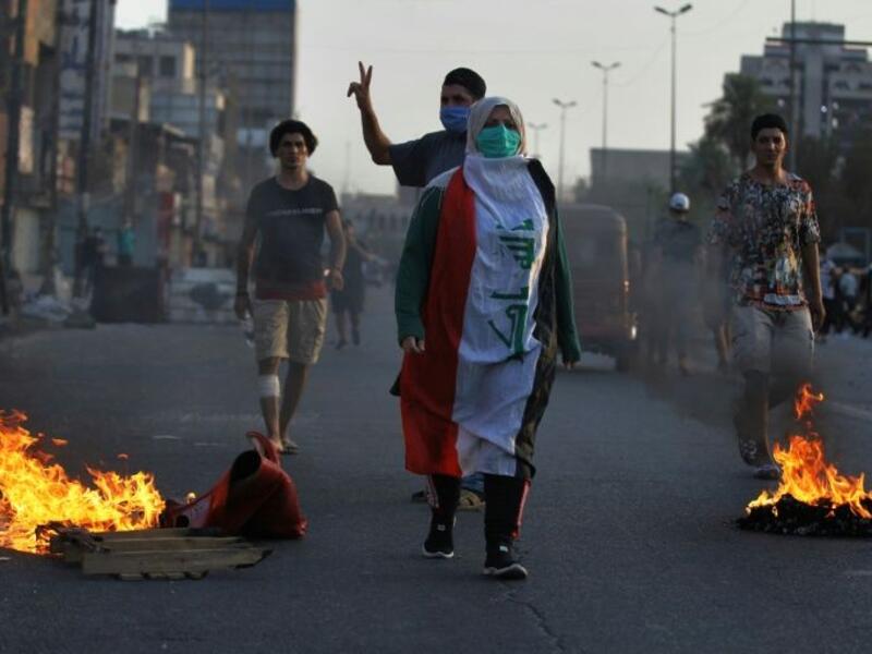 Iraqi demonstrators clash with security forces in a square in central Baghdad Iraqi demonstrators clash with security forces in a square in central Baghdad (AFP Photo/AHMAD AL-RUBAYE)