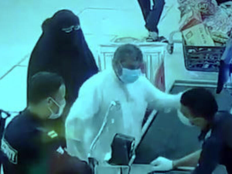 The attacker slapping a worker across the face at the Sabah Al-Ahmad cooperative supermarket. (Twitter/ Video Screenshot)