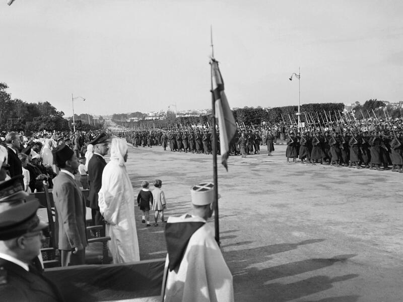 People and officials, in which Moulay Hassan (L), future king of Morocco Hassan II, attend the ceremonies of commemorations marking the anniversary of the 11 November 1918 armistice, in November 1945, in Rabat, Morocco. AFP