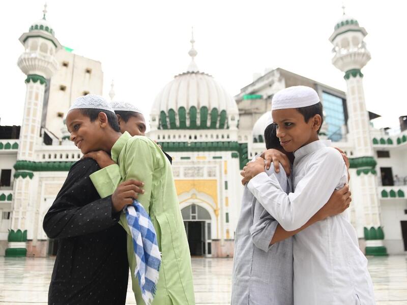 Muslim devotees greet each other after offering a special morning prayer on the occasion of Eid al-Adha, the feast of sacrifice, at the Jama Masjid Khairuddin in Amritsar on August 1, 2020. NARINDER NANU / AFP