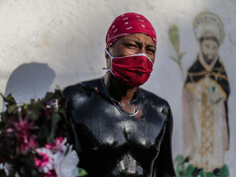 A Catholic faithful smeared in burnt oil poses for a picture as he takes part in the opening of the ten-day celebration of the Santo Domingo de Guzman festival, outside the Las Sierritas de Santo Domingo church in Managua, on August 1, 2020 amid the COVID-19 novel coronavirus pandemic. Despite the Catholic Church cancelling all religious activities due to the coronavirus pandemic, devotees gathered outside the church for the celebration. Inti OCON / AFP