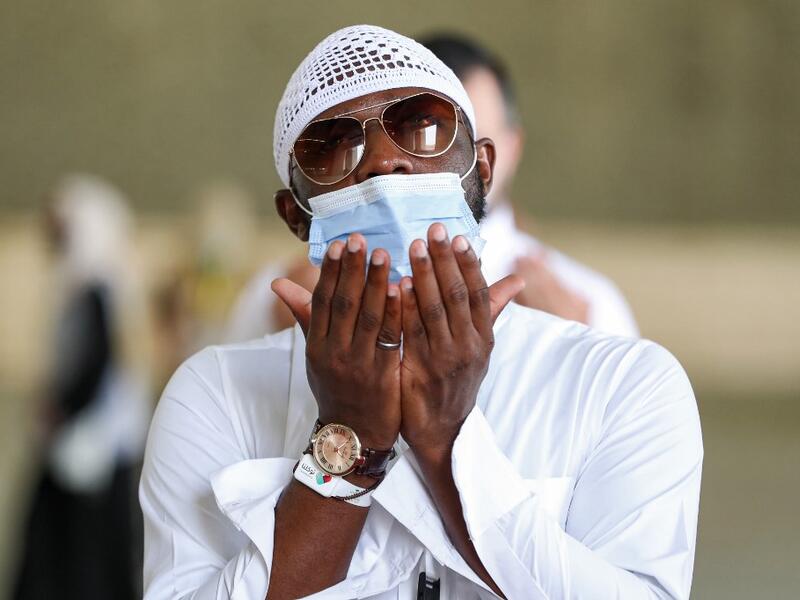 A Muslim pilgrim, clad in a face mask due to the COVID-19 coronavirus pandemic, prays after throwing pebbles as part of the symbolic al-A'qabah (stoning of the devil ritual) at the Jamarat Bridge during the Hajj pilgrimage in Mina, near Saudi Arabia's holy city of Mecca, on August 2, 2020. Massive crowds in previous years triggered deadly stampedes during the ritual, but this year only up to 10,000 Muslims are taking part after millions of international pilgrims were barred because of the covid-19 pandemic 