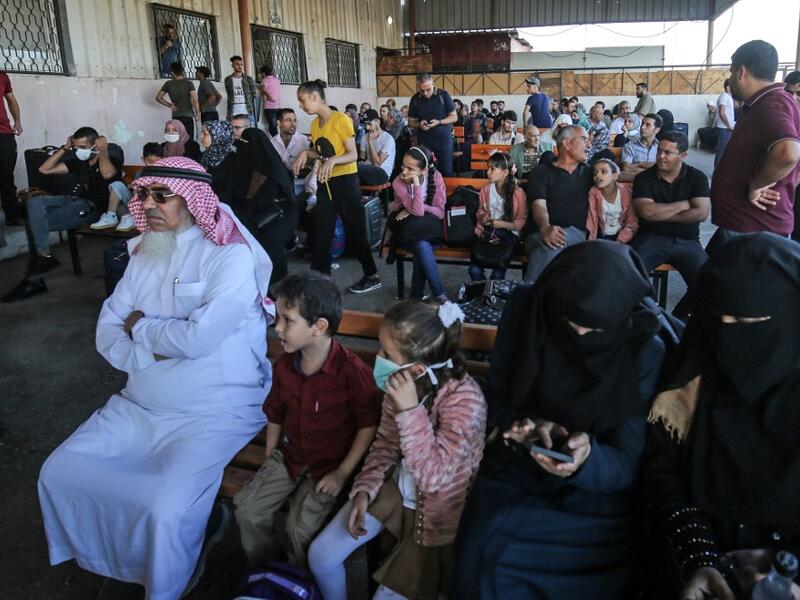 Palestinians wait to cross to the Egyptian side of Rafah border crossing after months of closure due to the coronavirus pandemic in the southern Gaza Strip, on August 11, 2020. SAID KHATIB / AFP