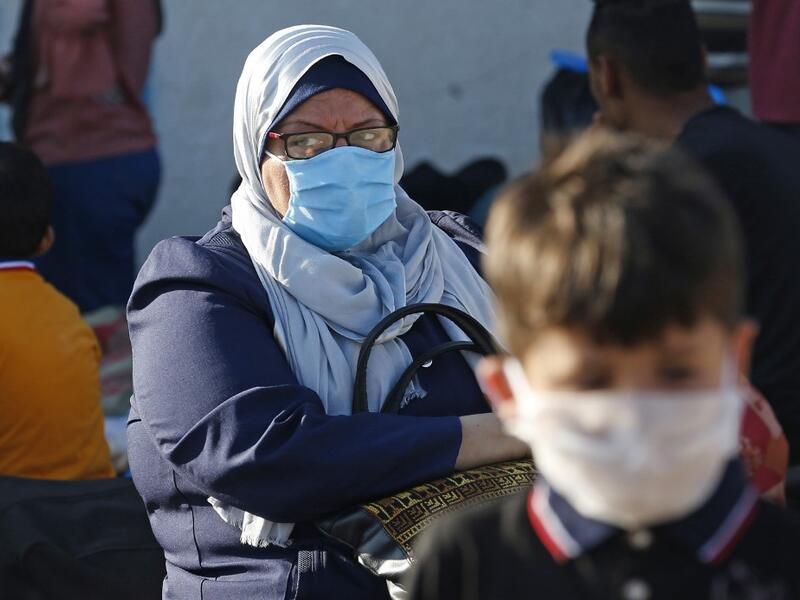 Palestinians wait to cross to the Egyptian side of Rafah border crossing after months of closure due to the coronavirus pandemic in the southern Gaza Strip, on August 11, 2020. SAID KHATIB / AFP