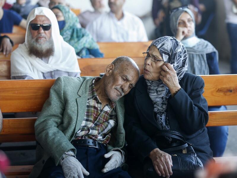 Palestinians wait to cross to the Egyptian side of Rafah border crossing after months of closure due to the coronavirus pandemic in the southern Gaza Strip, on August 11, 2020. SAID KHATIB / AFP